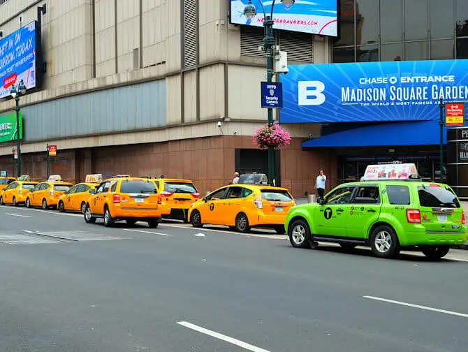 New York Taxis - Lime-green taxi next to yellow cabs