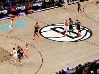 Brooklyn Nets Tickets - Game action at Barclays Center with players on court featuring the Nets logo